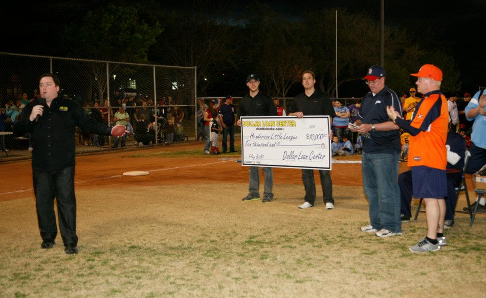 Chuck Brennan of Dollar Loan Center presenting the Henderson Little League with a $10,000 check