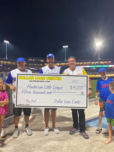 Chuck Brennan presents large 15K check to Henderson Little League Representatives